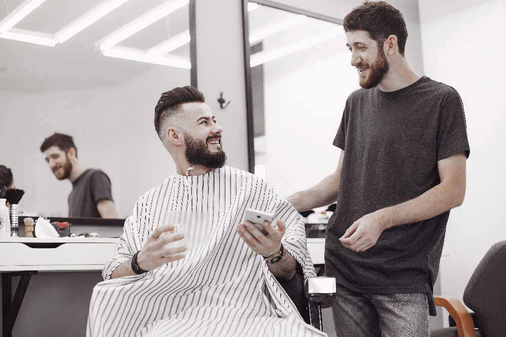 stylish-man-sitting-in-a-barbershop-CKF2KVB.jpg
