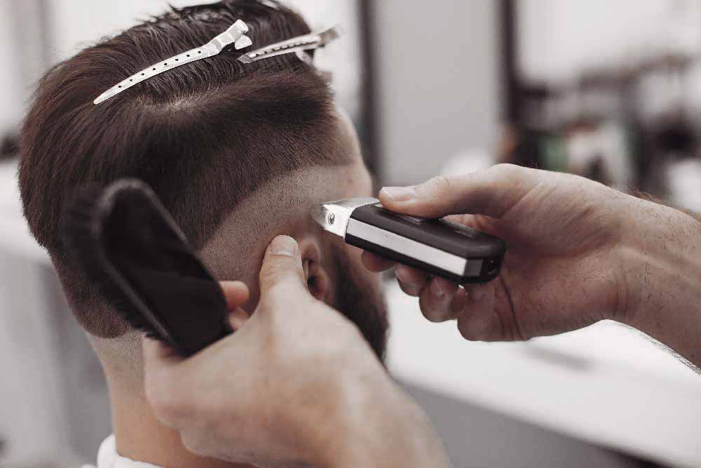 stylish-man-sitting-in-a-barbershop-Z7WU8LK.jpg